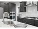 Modern kitchen with dark gray cabinetry, stainless steel appliances, white subway tile backsplash, and center island at 116 Charlotte Knoll St # 7, Zebulon, NC 27597