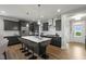 Beautiful kitchen features dark cabinets, stainless appliances, and a large center island with seating at 116 Charlotte Knoll St # 7, Zebulon, NC 27597