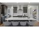 Modern kitchen features a large island with seating, stainless steel appliances, and pendant lighting at 116 Charlotte Knoll St # 7, Zebulon, NC 27597