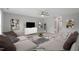 Spacious living room featuring comfortable seating, modern decor, ceiling fan, and a view of the hallway at 116 Charlotte Knoll St # 7, Zebulon, NC 27597