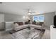 Spacious living room with large sectional, modern decor, and a bright window view at 116 Charlotte Knoll St # 7, Zebulon, NC 27597