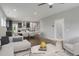 Open floor plan showing the kitchen, dining, and living area with white furniture and wood floors at 116 Charlotte Knoll St # 7, Zebulon, NC 27597
