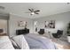 Bedroom with light blue bedding, modern artwork, ceiling fan, and decor in a neutral color scheme at 116 Charlotte Knoll St # 7, Zebulon, NC 27597