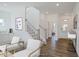Bright and airy entryway with hardwood floors and staircase at 148 Charlotte Knoll St # 8, Zebulon, NC 27597
