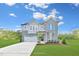 Two-story gray brick and siding house with a three-car garage and landscaping at 148 Charlotte Knoll St # 8, Zebulon, NC 27597