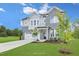 Two-story gray brick and siding house with a three-car garage and landscaping at 148 Charlotte Knoll St # 8, Zebulon, NC 27597
