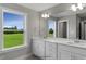 Double vanity bathroom with large mirror and window views at 178 Charlotte Knoll St # 9, Zebulon, NC 27597