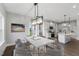 Open concept dining area with kitchen view and modern chandelier at 178 Charlotte Knoll St # 9, Zebulon, NC 27597