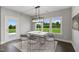 Bright dining room with large windows and modern light fixture at 178 Charlotte Knoll St # 9, Zebulon, NC 27597