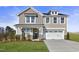 Two-story home with gray siding, white trim, and a two-car garage at 178 Charlotte Knoll St # 9, Zebulon, NC 27597