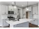 Modern kitchen with white cabinets, quartz countertops, and stainless steel appliances at 178 Charlotte Knoll St # 9, Zebulon, NC 27597