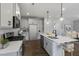 Modern kitchen with island, white cabinets, and stainless steel appliances at Tbd Charlotte Knoll St # 9, Zebulon, NC 27597