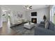 Bright living room features fireplace, hardwood floors, and large windows at 178 Charlotte Knoll St # 9, Zebulon, NC 27597