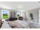 Main bedroom with large windows, plush carpet, and backyard views at 178 Charlotte Knoll St # 9, Zebulon, NC 27597