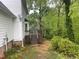 View of the home's exterior with a wooden deck and tree-filled backyard at 118 Trafalgar Ln, Cary, NC 27513