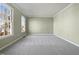 Bright bedroom with carpet, neutral walls, and large windows at 118 Trafalgar Ln, Cary, NC 27513