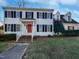 Two story home with red front door and manicured lawn at 118 Trafalgar Ln, Cary, NC 27513
