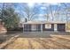 Charming home with wood siding, screened porch, and mature trees at 1219 Carlton Ave, Burlington, NC 27217