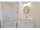 Bright bathroom features a tub-shower combo, decorative mirror, and vanity with storage at 1219 Carlton Ave, Burlington, NC 27217