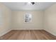 Bright bedroom showing hardwood floors, a ceiling fan, and a large window at 1219 Carlton Ave, Burlington, NC 27217