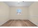 Bedroom showcasing hardwood floors and a window with natural light at 1219 Carlton Ave, Burlington, NC 27217