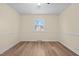 Bedroom featuring wood floors, window, and wainscoting at 1219 Carlton Ave, Burlington, NC 27217