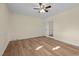 Bedroom featuring hardwood floors, a ceiling fan, and a mirrored closet door at 1219 Carlton Ave, Burlington, NC 27217