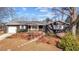 Charming one-story home with wood siding, porch, and mature trees at 1219 Carlton Ave, Burlington, NC 27217