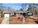 Charming one-story home with wood siding, porch, and mature trees at 1219 Carlton Ave, Burlington, NC 27217