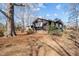 Exterior side view shows the home's architecture and surrounding landscaping, including mature trees at 1219 Carlton Ave, Burlington, NC 27217