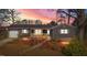 Charming one-story home featuring neutral siding, a cozy front porch, and a manicured front yard at 1219 Carlton Ave, Burlington, NC 27217