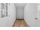 Bright hallway featuring built-in shelving, wood floor, and white trim at 1219 Carlton Ave, Burlington, NC 27217