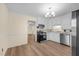 Bright kitchen featuring stainless steel appliances and light wood-look flooring at 1219 Carlton Ave, Burlington, NC 27217