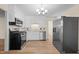 Bright kitchen featuring stainless steel appliances and light wood-look flooring at 1219 Carlton Ave, Burlington, NC 27217