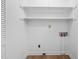 Neat laundry room with white shelving and hook-ups for washer and dryer at 1219 Carlton Ave, Burlington, NC 27217
