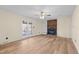 Living room featuring a brick fireplace, built-in shelving, ceiling fan, and wood-look floors at 1219 Carlton Ave, Burlington, NC 27217