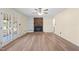 Open living room with wood flooring, brick fireplace, and built-in shelving at 1219 Carlton Ave, Burlington, NC 27217