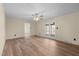 Large living room featuring wood-look floors, neutral walls, a ceiling fan, and exterior access at 1219 Carlton Ave, Burlington, NC 27217