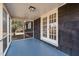 Relaxing screened porch featuring tongue and groove ceiling and blue painted floor at 1219 Carlton Ave, Burlington, NC 27217