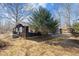 Charming home with wood siding, screened porch, and mature trees at 1219 Carlton Ave, Burlington, NC 27217