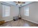 Bedroom with two windows, hardwood floors and ceiling fan at 131 Bessie Ln, Roxboro, NC 27574