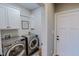 Laundry room with washer, dryer and cabinets at 131 Bessie Ln, Roxboro, NC 27574