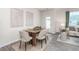 Dining area with a wood table and four chairs, featuring neutral colors and natural light at 149 Holton St, Smithfield, NC 27577