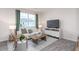 Living room with light colored sofa, wooden coffee table and large TV at 149 Holton St, Smithfield, NC 27577