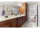 Double vanity bathroom with ample storage and a view into the bedroom at 15 Madeira Dr, Franklinton, NC 27525