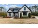 Craftsman style home with white siding and black accents, nicely landscaped yard at 15 Willow Bend Dr, Youngsville, NC 27596