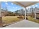 Backyard features a covered patio, a well-maintained lawn, and wrought iron fencing at 1700 Cary Reserve Dr, Cary, NC 27519