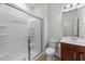 Well-lit bathroom with a glass-enclosed shower, dark wood vanity, and a modern sink at 1700 Cary Reserve Dr, Cary, NC 27519