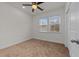 Comfortable bedroom features neutral carpet, a ceiling fan, and a window with bright natural light at 1700 Cary Reserve Dr, Cary, NC 27519
