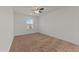 Neutral bedroom with carpet flooring, a ceiling fan, and a window letting in natural light at 1700 Cary Reserve Dr, Cary, NC 27519